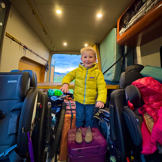 kid in adventure van with gear