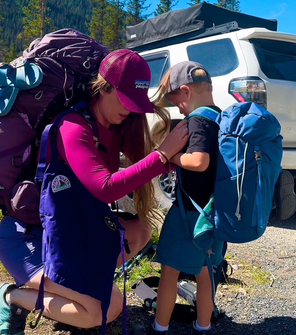 toddler and backpacking mom standing in front of 4runner