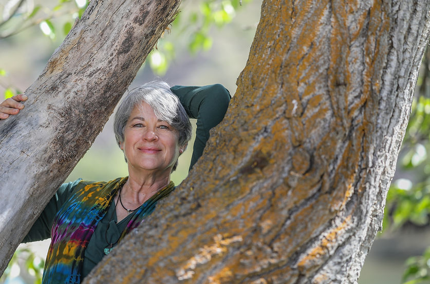 Cynthia Dano, cancer coach outside against tree