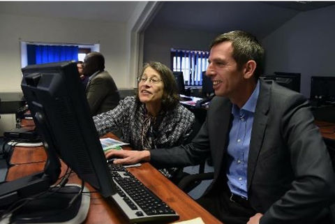 Culmen team teaching a student on a computer