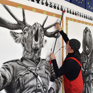 Valeriu Mladin in his studio, working on monumental drawings from the Political Bestiary series; documentary images taken over 12 years, capturing the working atmosphere, the scale of the studio, the creative process and the charcoal technique, with hybrid figures combining human bodies and animal heads.