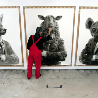 Valeriu Mladin in his studio, working on monumental drawings from the Political Bestiary series; documentary images taken over 12 years, capturing the working atmosphere, the scale of the studio, the creative process and the charcoal technique, with hybrid figures combining human bodies and animal heads.