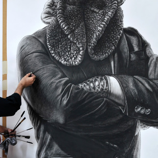 Valeriu Mladin in his studio, working on monumental drawings from the Political Bestiary series; documentary images taken over 12 years, capturing the working atmosphere, the scale of the studio, the creative process and the charcoal technique, with hybrid figures combining human bodies and animal heads.