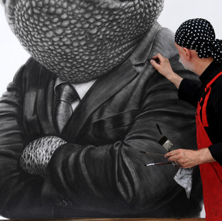 Valeriu Mladin in his studio, working on monumental drawings from the Political Bestiary series; documentary images taken over 12 years, capturing the working atmosphere, the scale of the studio, the creative process and the charcoal technique, with hybrid figures combining human bodies and animal heads.