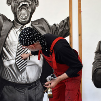 Valeriu Mladin in his studio, working on monumental drawings from the Political Bestiary series; documentary images taken over 12 years, capturing the working atmosphere, the scale of the studio, the creative process and the charcoal technique, with hybrid figures combining human bodies and animal heads.