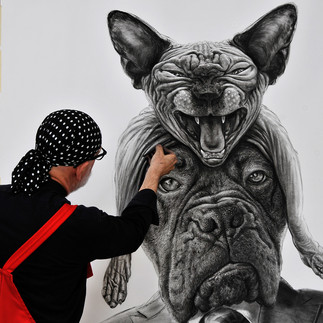 Valeriu Mladin in his studio, working on monumental drawings from the Political Bestiary series; documentary images taken over 12 years, capturing the working atmosphere, the scale of the studio, the creative process and the charcoal technique, with hybrid figures combining human bodies and animal heads.