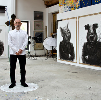 Valeriu Mladin in his studio, working on monumental drawings from the Political Bestiary series; documentary images taken over 12 years, capturing the working atmosphere, the scale of the studio, the creative process and the charcoal technique, with hybrid figures combining human bodies and animal heads.