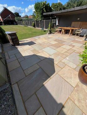 Indian Sandstone patio with grassed area beyond