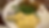 Plate with mashed potatoes, green beans, and stuffing. A spoon rests on the plate. Brown wood table background. Cozy dining scene.