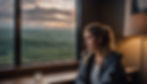 pretty white woman gazing out of a window on a cruise at sea