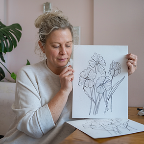 a-casual-photo-of-an-adult-white-woman-holding adrawing