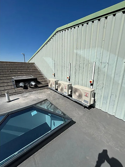 Three air conditioning units installed on rooftop