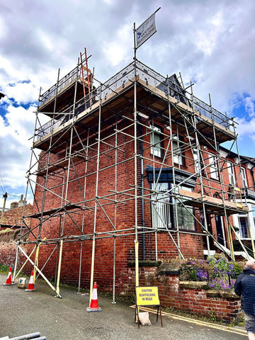 Red Brick Domestic Home surrounded by Scaffolding