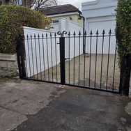 Black metal gate with decorative finials.