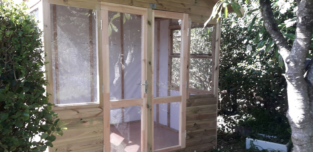 Wood shed with toughened glass windows