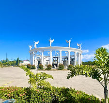 White stone Pillar of Angels monument surrounded by green grass at Manila Memorial Park, Sta. Rosa