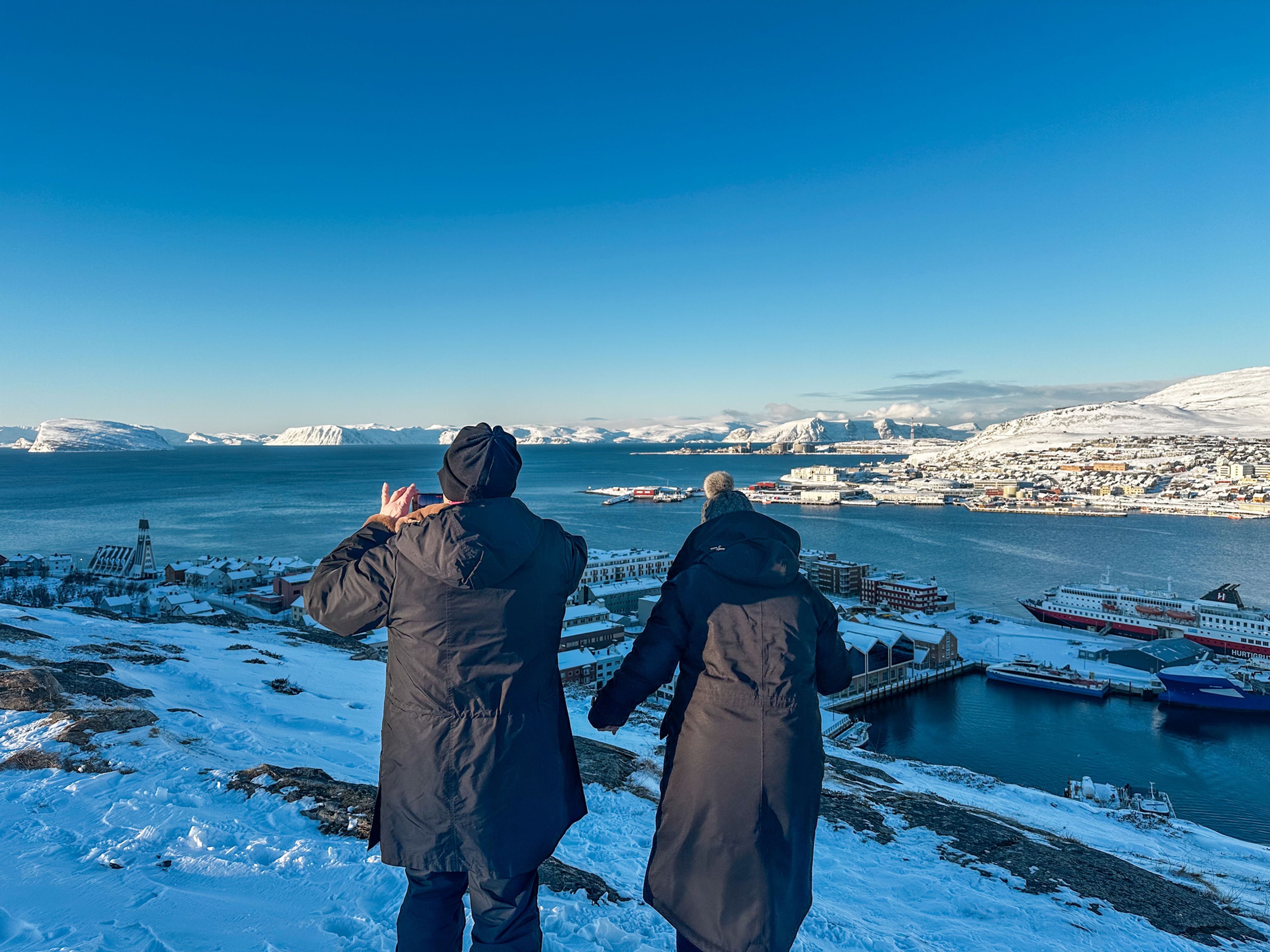 Two women take photographs from Hammerfest from Salen viewpoint