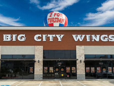 Promotional graphic for Big City Wings Wednesday Kids Eat Free Special - Buy any adult entree and get 2 FREE Kids Meals all day long every Wednesday!