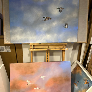a swan painting, and a duck painting in pinks and blues