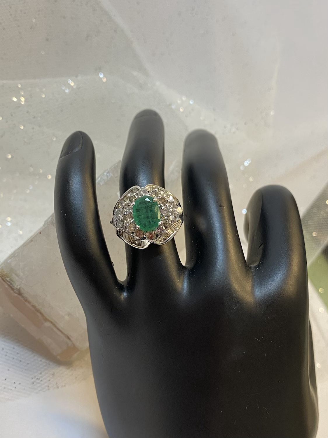Oval emerald with diamond accents
