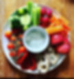 A vibrant and wholesome platter of fresh veggies, crisp apple slices, artisanal bread, and a creamy yogurt dip, perfect for a healthy snack.