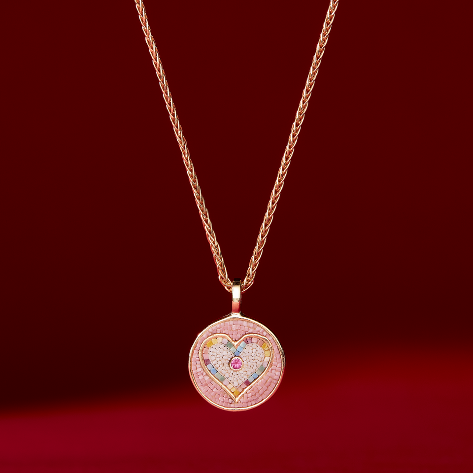 Jewellery photography shot by jewellery photographer of a Mosaic gold necklace on a deep red background.