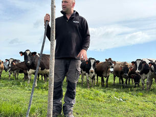 Asher Bowyer holding a poplar pole during a poplar planting sustainability project with ALFA Trust.