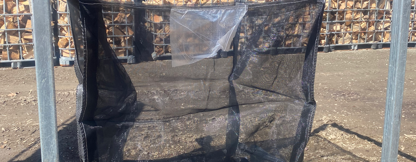 Reusable ALFA firewood bag with reinforced lifting loops for fast loading, tipping and low-labour firewood handling.