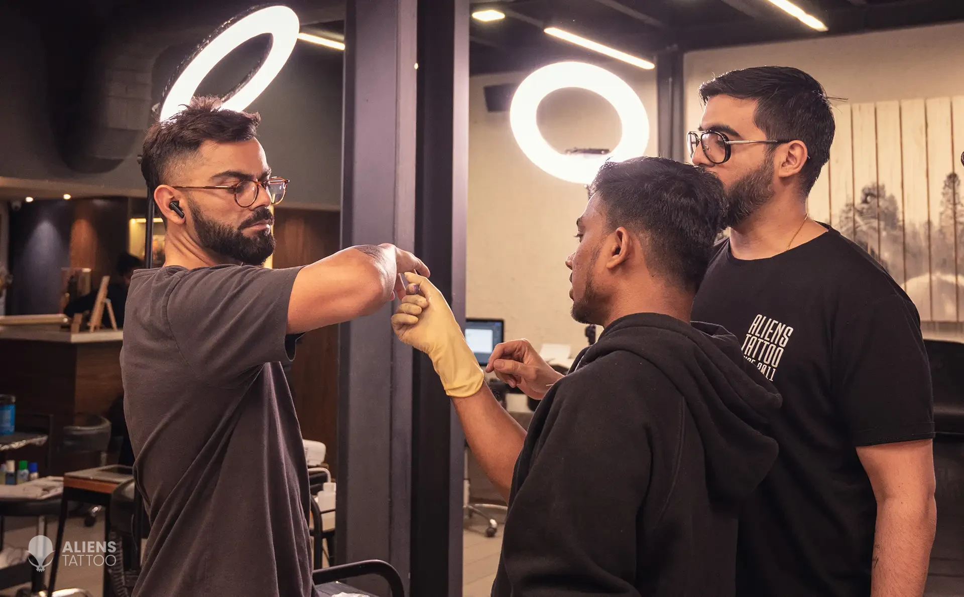 Sunny Bhanushali and Devendra Palav working on Virat Kohli's arm band tattoo
