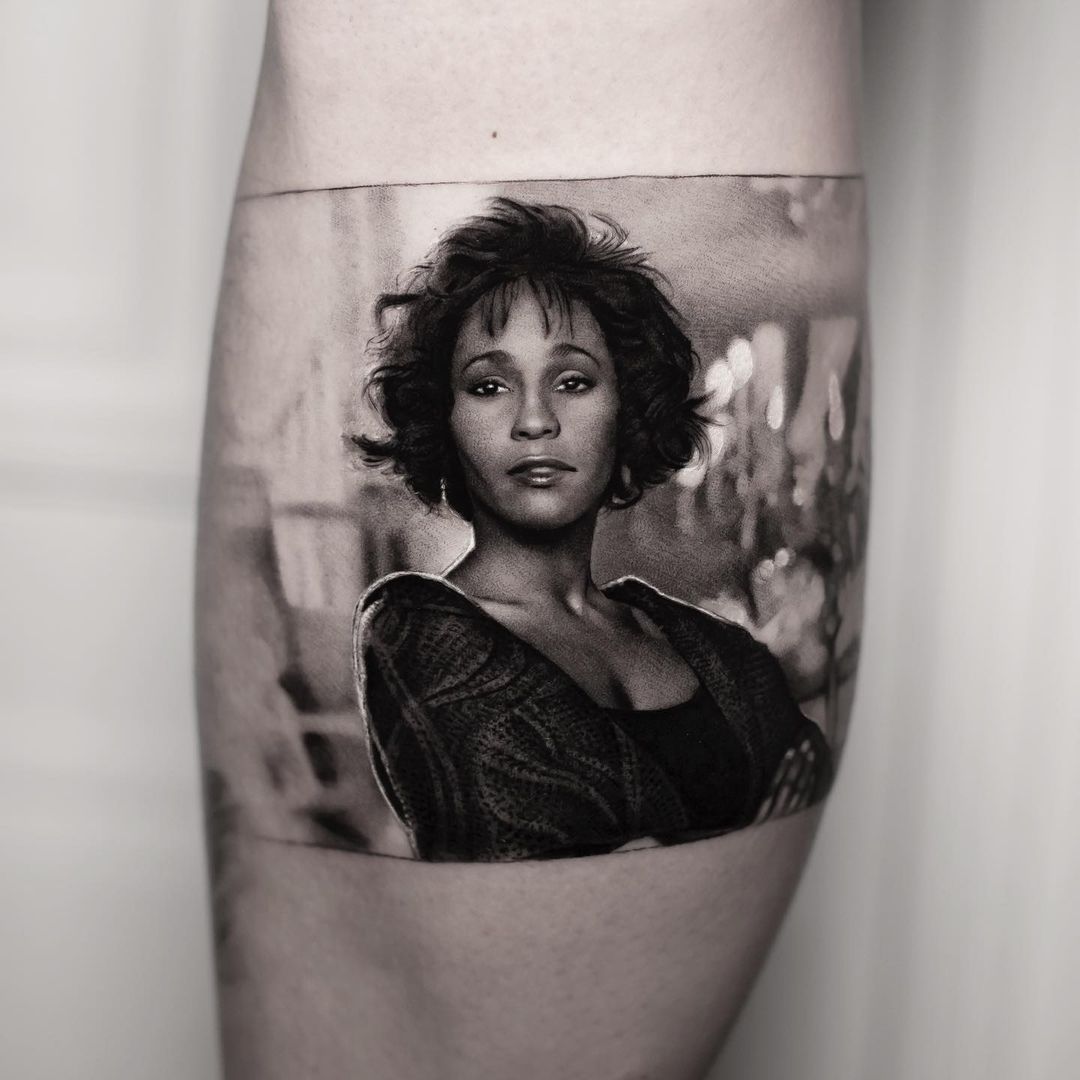 black and grey celebrity portrait tattoo