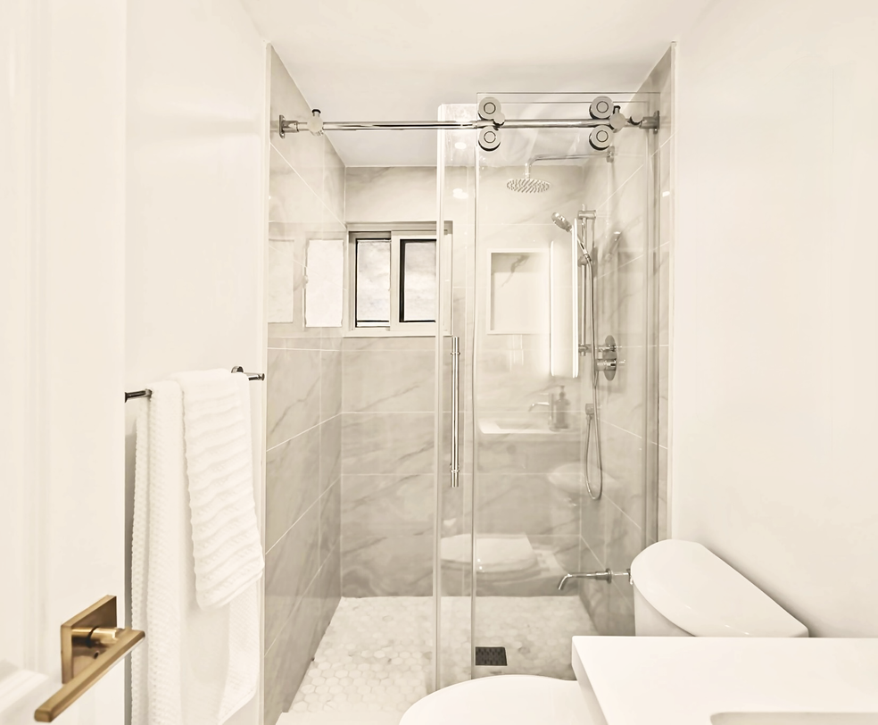 Recently updated 3-piece bathroom with a walk-in glass shower, modern vanity, and bright ceiling lighting.