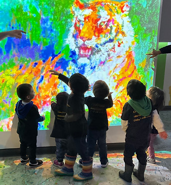 Group of children viewing projection of tiger