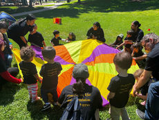 Group lowering colored parachute outside