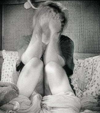 Figure rises from the bed still covering their eyes in a blurry haze