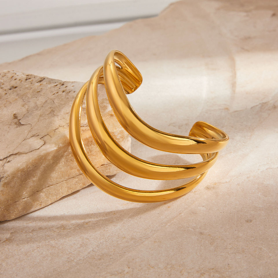 Gold triple-layer cuff bracelet on display, 9to5Jewels, elegant jewelry fashion.