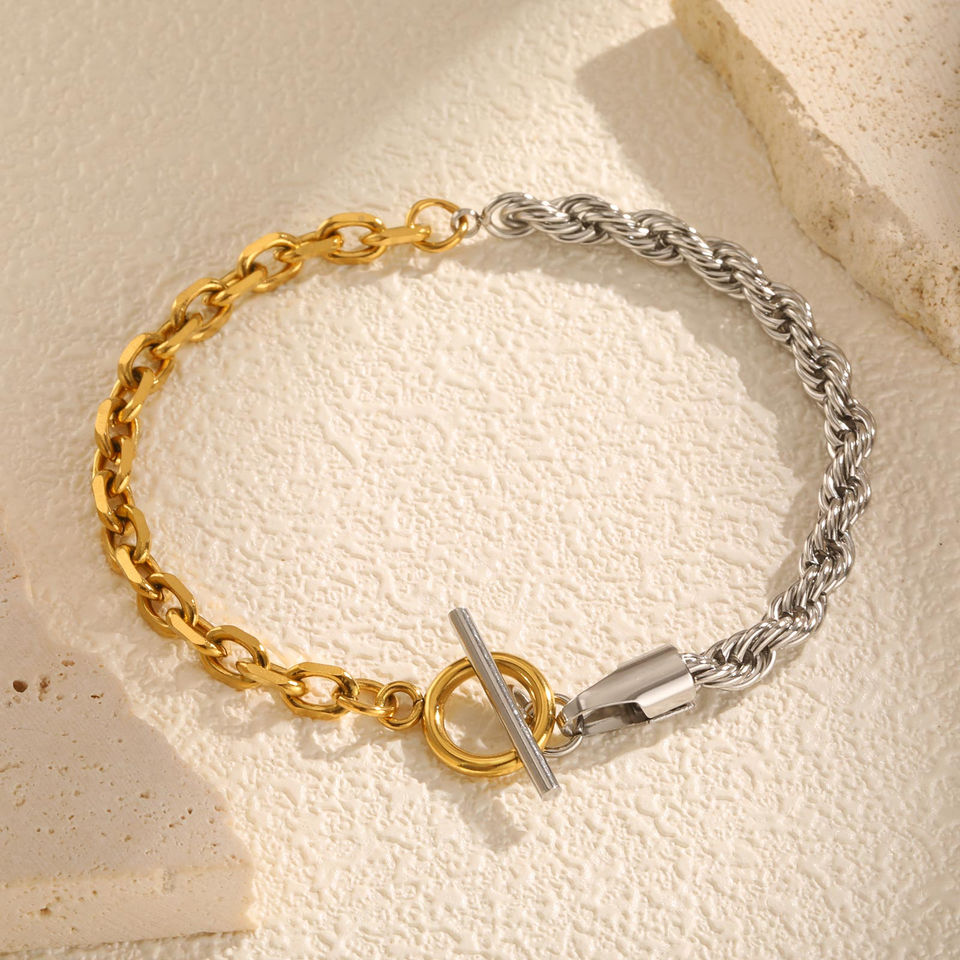 Two-tone bracelet with a toggle clasp on a neutral surface. 9to5Jewels
