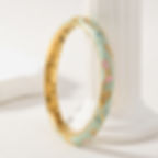 Gold bangle bracelet with blue and pink enamel design on white surface 9to5Jewels