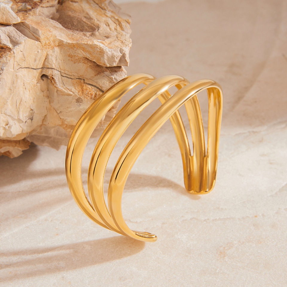 Gold layered cuff bracelet displayed, elegant design, ideal for daily wear. 9to5Jewels