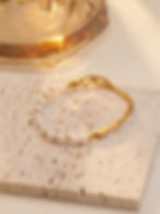 Elegant gold bracelet with pearls, featuring a unique wavy design, 9to5Jewels.