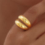 Woman's hand wearing a gold double ring, holding the ring. 9to5Jewels