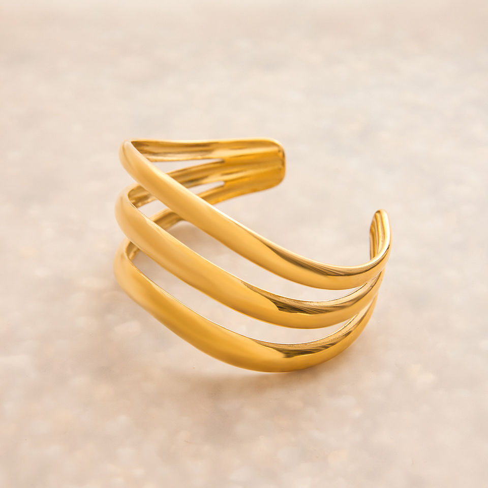 Gold spiral bracelet on a white background, jewelry product photography. 9to5Jewels