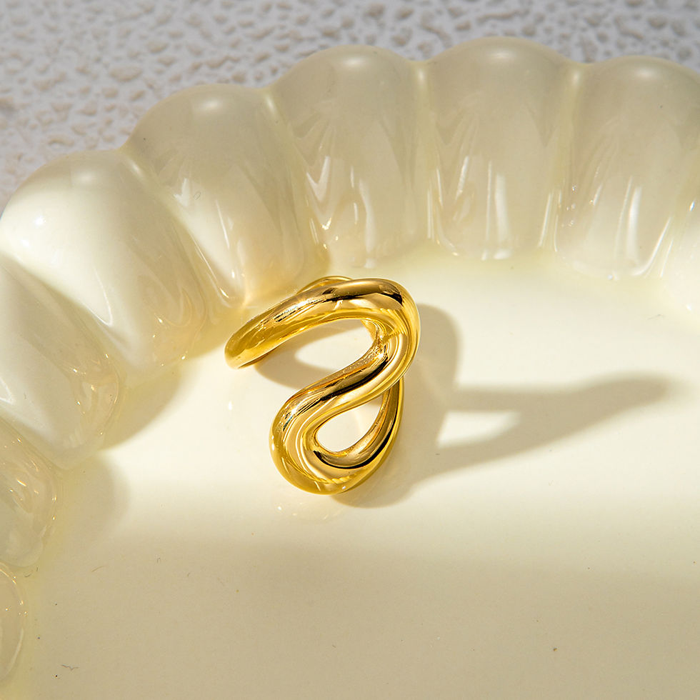 Gold ear cuff on a white surface, minimalist design, 9to5Jewels.