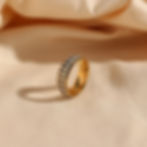 Elegant gold ring with black and white checkered pattern, Zircona Ring, studio shot.