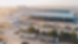 aerial-view-factory-trucks-parked-near-warehouse-daytime.jpg