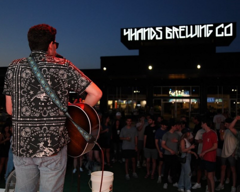 Man playing guitar on stage at The Hub STL