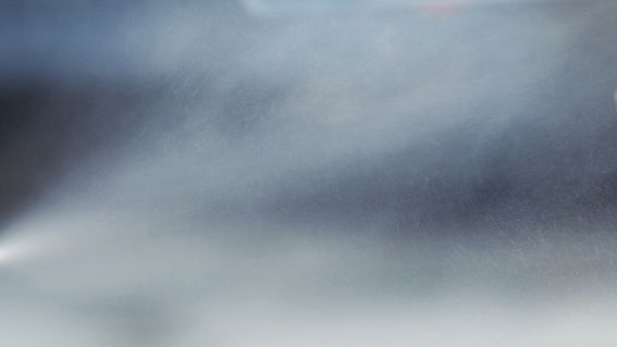 A dynamic wetting line issue that leads to bubble formation under the coating, becoming more challenging to manage as line speed increases is "Air Entrapment".