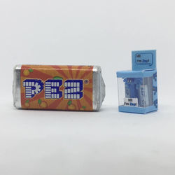 Miniature next to a half size candy pack for scale