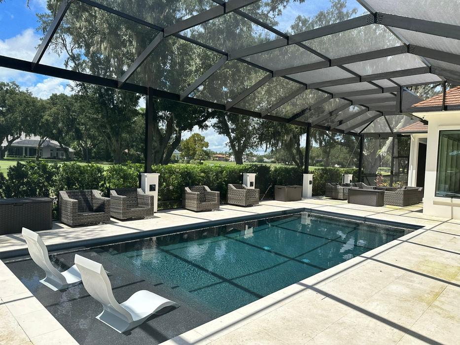 Screen Roof Enclosure with a pool and pool chairs