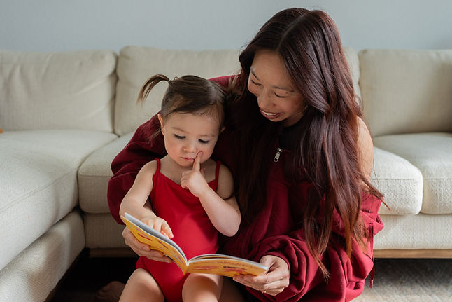 Jackelyn Ho reading Bodybuilding for Babies to her daughter Emi