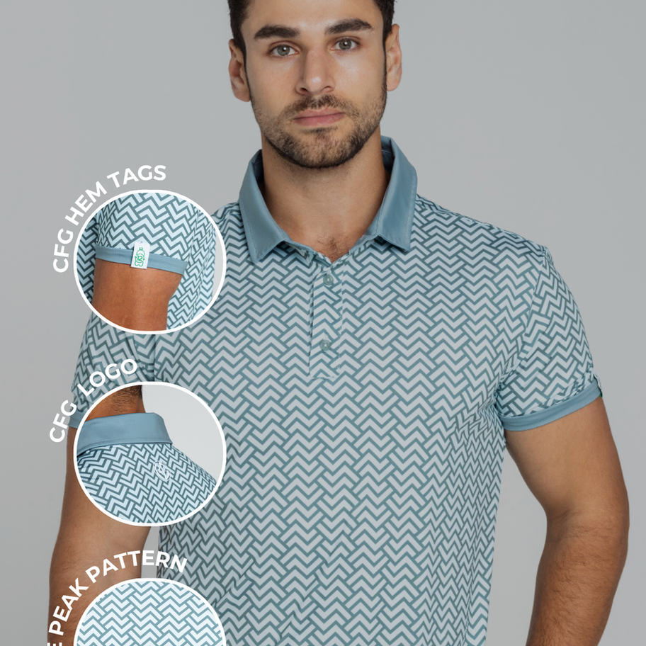 A man wearing a patterned polo shirt with a solid blue collar and sleeve trim, paired with white pants. The design is casual